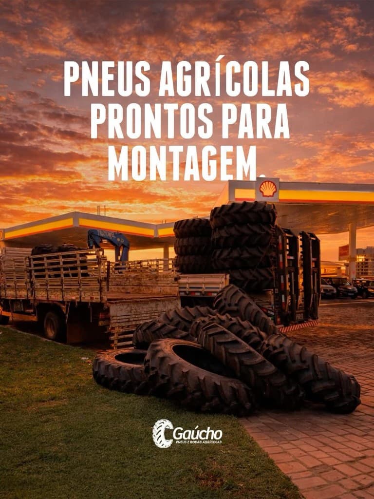 Pneus agrícolas prontos para montagem em pátio ao entardecer, com caminhão e conjunto de pneus em destaque.